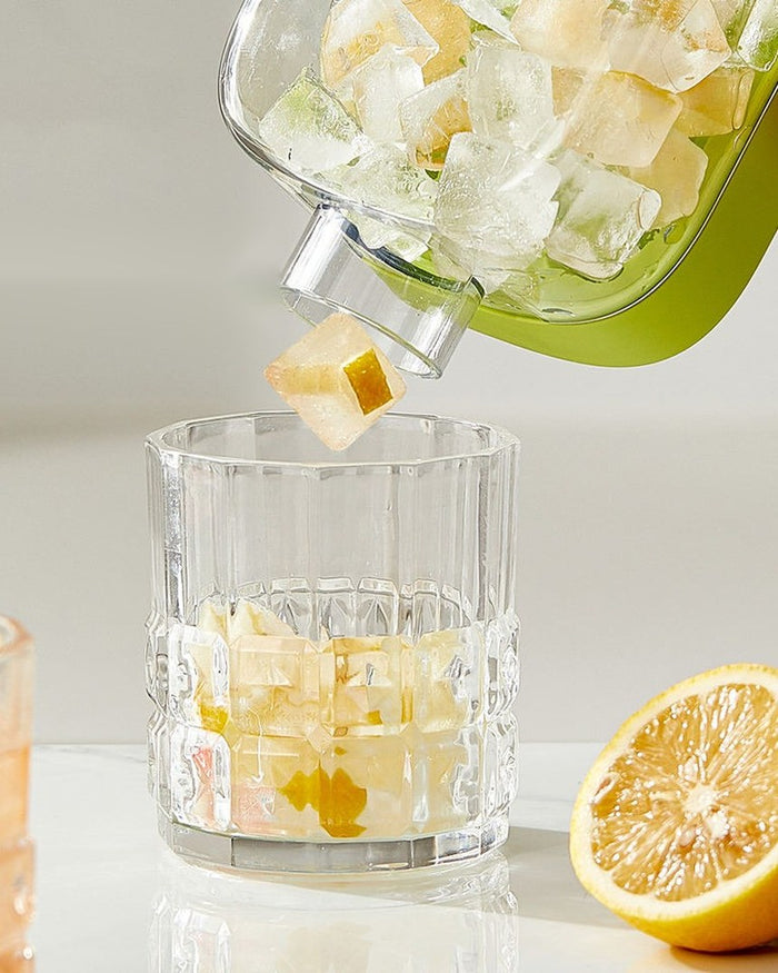 ChillMate ice ball bottle pouring crystal-clear ice spheres into a glass